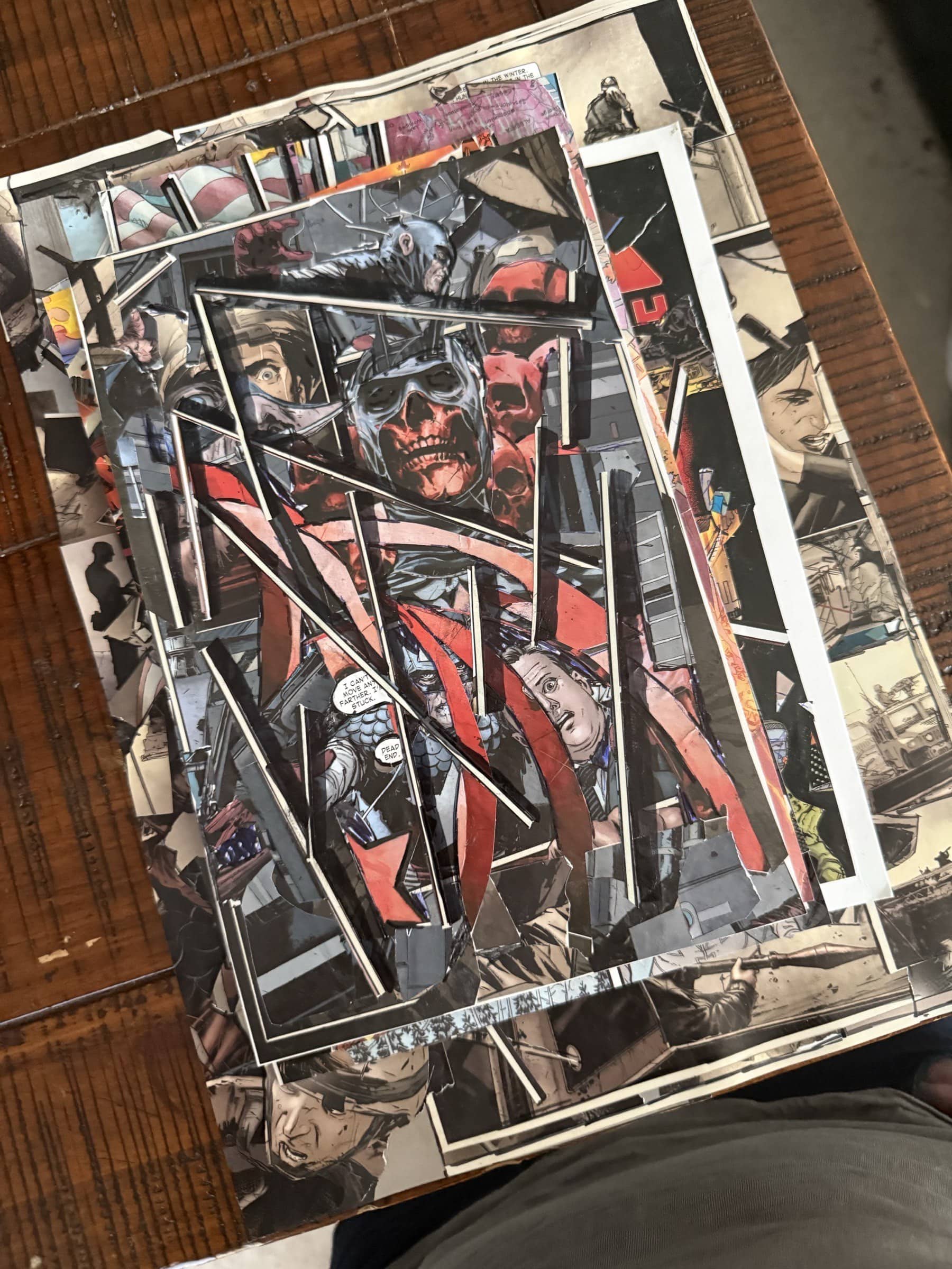 Dark red-and-black collage with skull imagery, faces, and fractured structural bands.