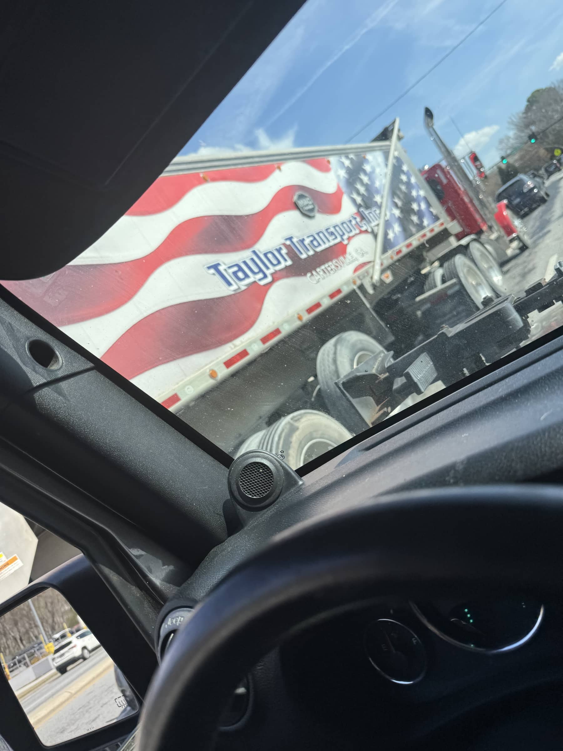 Tractor trailer seen through the windshield on the drive to Charlie's Collectibles.