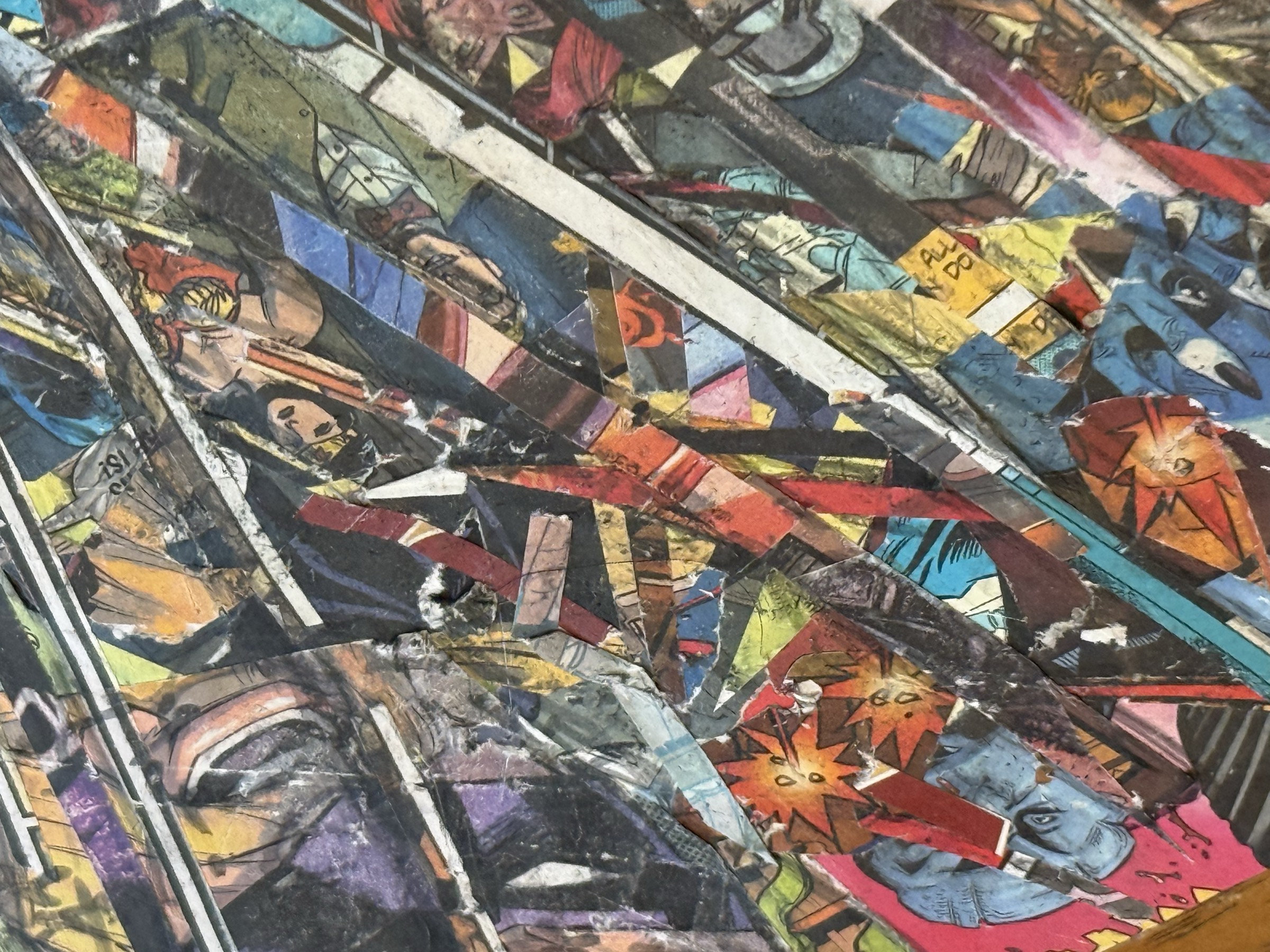 Detail view showing scratched surfaces, diagonal compression, and masked hero fragments inside the lower field.